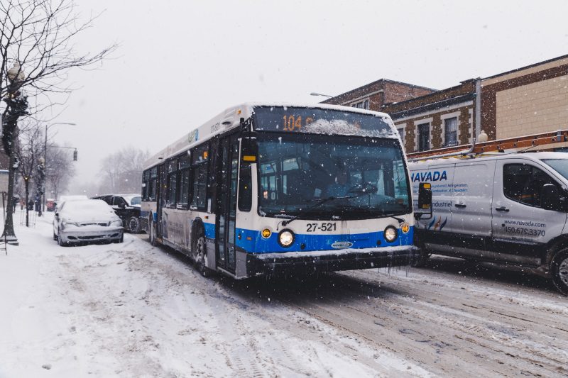 Bus driving on a snowy city street